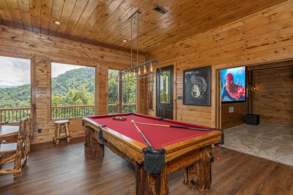 Pool table in the game room at Black Bears & Biscuits Lodge, a 6 bedroom cabin rental located in Pigeon Forge