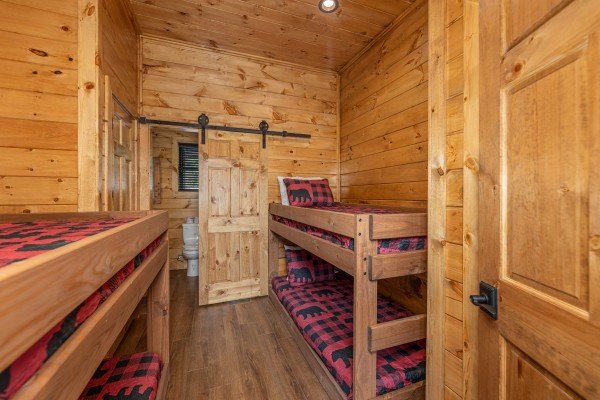 Bedroom with four twin bunk beds at Black Bears & Biscuits Lodge, a 6 bedroom cabin rental located in Pigeon Forge