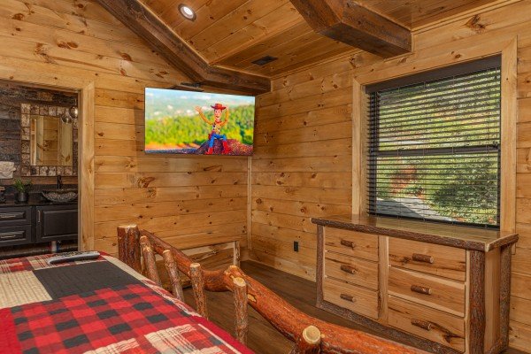 Dresser and TV in a bedroom at Black Bears & Biscuits Lodge, a 6 bedroom cabin rental located in Pigeon Forge