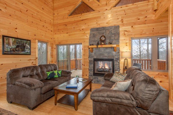 Living room with see through fireplace at Happy Bear's Hideaway, a 2 bedroom cabin rental located in Gatlinburg