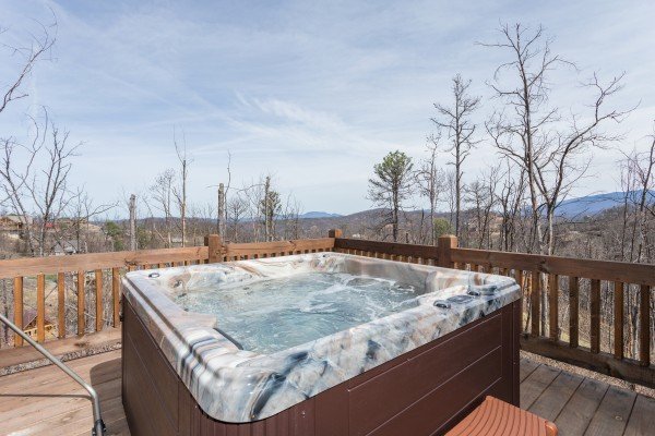 Hot tub on a deck with mountain views at Moonlight Inn Gatlinburg, a 2 bedroom cabin rental located in Gatlinburg