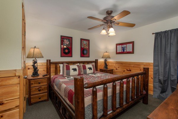 Bedroom with a log bed and two night stands at Mountain Music, a 5 bedroom cabin rental located in Pigeon Forge