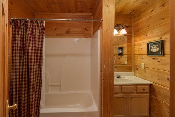 Bathroom with a tub and shower at Cabin Sweet Cabin, a 1 bedroom cabin rental located in Gatlinburg