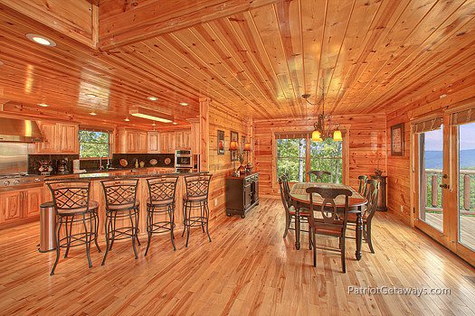 Breakfast bar and dining room table at Majestic Views, a 3 bedroom cabin rental located in Pigeon Forge