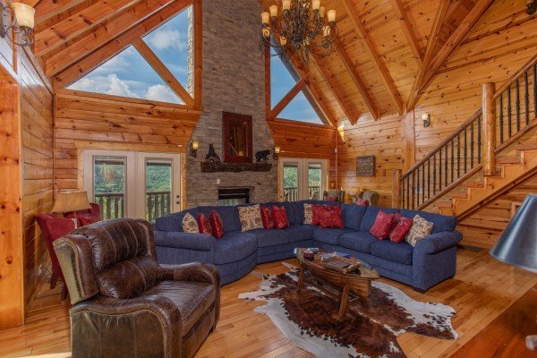 Large blue sectional sofa and recliner at Majestic Views, a 3 bedroom cabin rental located in Pigeon Forge