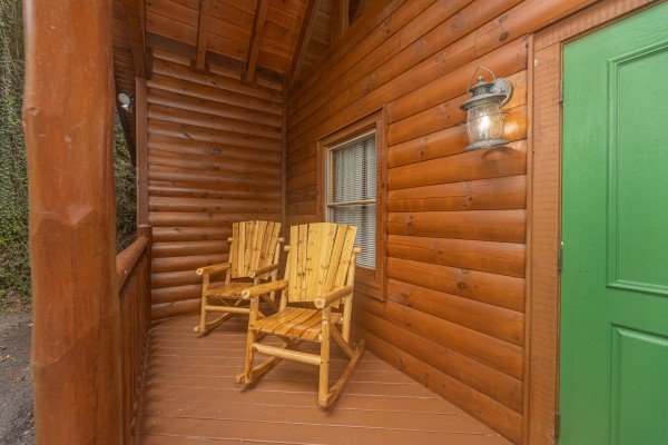 Rocking chairs on a deck at King Wolf Lodge, a 3 bedroom cabin rental located in Pigeon Forge