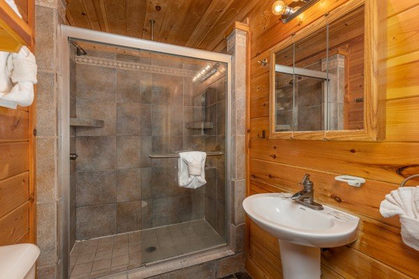 Bathroom with a walk in shower at King Wolf Lodge, a 3 bedroom cabin rental located in Pigeon Forge
