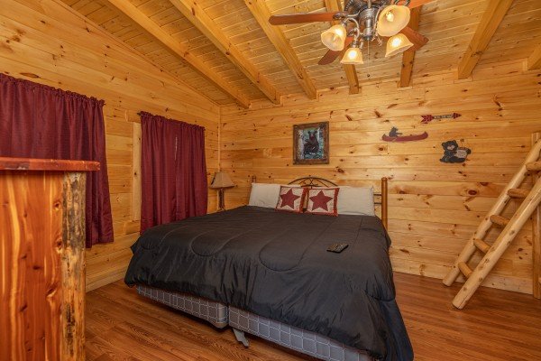 Bedroom with a king bed at King Wolf Lodge, a 3 bedroom cabin rental located in Pigeon Forge
