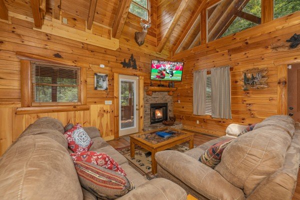Living room with fireplace and TV at King Wolf Lodge, a 3 bedroom cabin rental located in Pigeon Forge