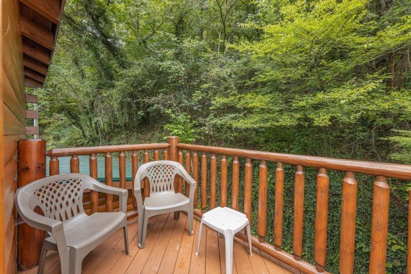 Upper deck with two chairs at King Wolf Lodge, a 3 bedroom cabin rental located in Pigeon Forge