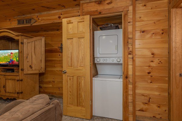 Stacked washer and dryer in a closet at Smoky Bears Creek, a 2 bedroom cabin rental located in Pigeon Forge