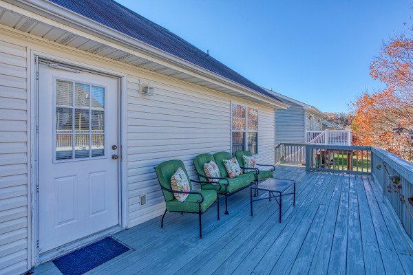 Back deck with seating at Peace at the River, a 3 bedroom cabin rental located in Pigeon Forge