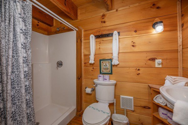 Bathroom with tub and shower at Licklog Hollow, a 1 bedroom cabin rental located in Pigeon Forge