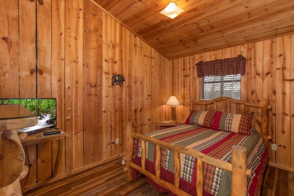 Loft bedroom with TV at Papa Bear, a 3 bedroom cabin rental located in Pigeon Forge