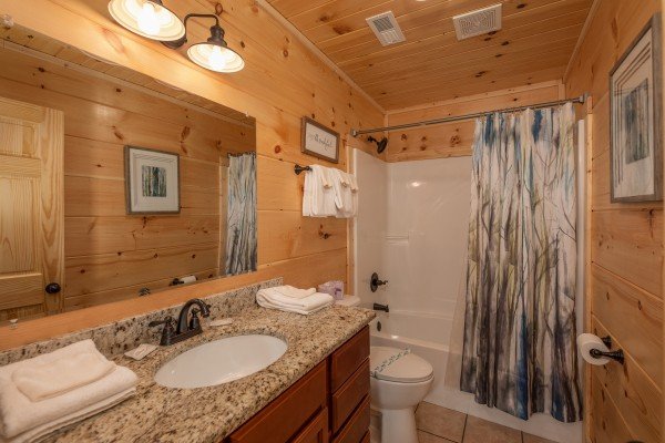 Bathroom with a tub and shower at Always Dream'n, a 6 bedroom cabin rental located in Pigeon Forge