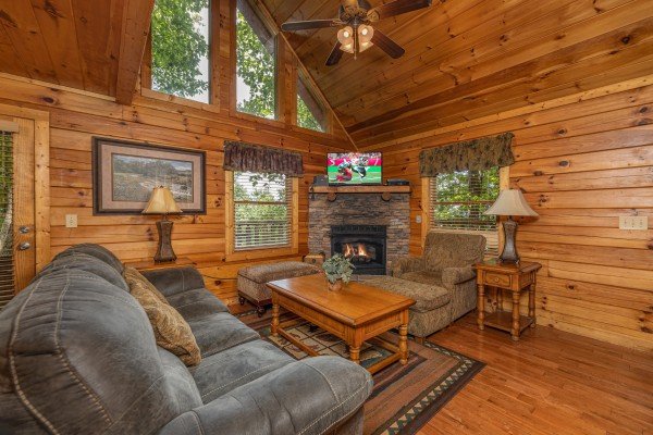 Fireplace and TV in a living room at Bearway to Heaven, a 2 bedroom cabin rental located in Gatlinburg