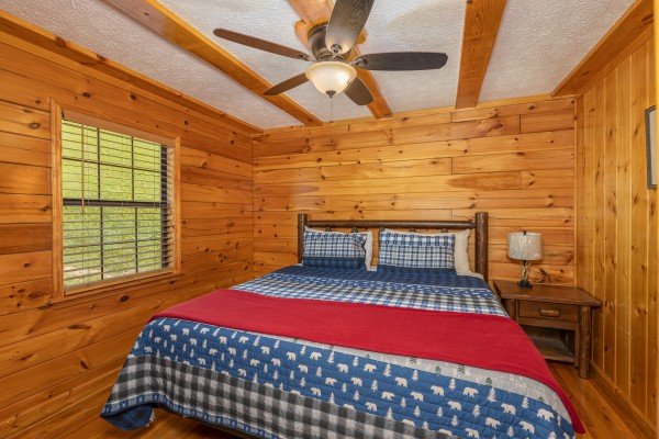 Bedroom with nightstand and lamp at Pool Side Lodge, a 6 bedroom cabin rental located in Pigeon Forge
