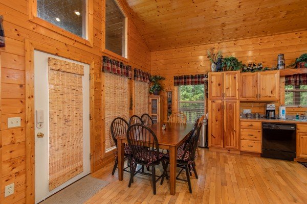 Dining space for eight in the kitchen at Into the Mist, a 3 bedroom cabin rental located in Pigeon Forge