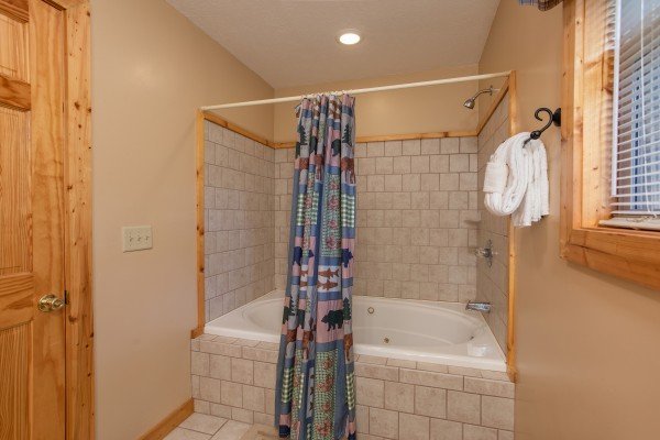 Bathroom with a jacuzzi tub and a shower at Into the Mist, a 3 bedroom cabin rental located in Pigeon Forge