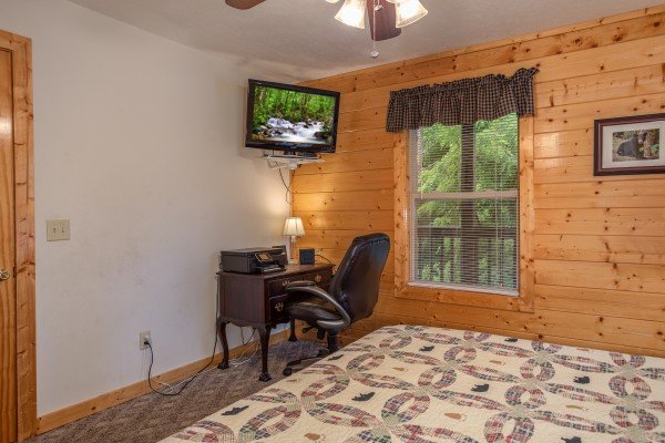 Bedroom with a writing desk and a tv at Into the Mist, a 3 bedroom cabin rental located in Pigeon Forge