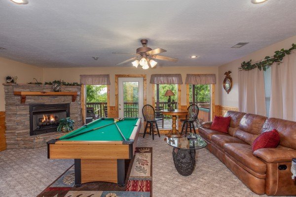 Game room with a pool table, bar table, and fireplace at Into the Mist, a 3 bedroom cabin rental located in Pigeon Forge