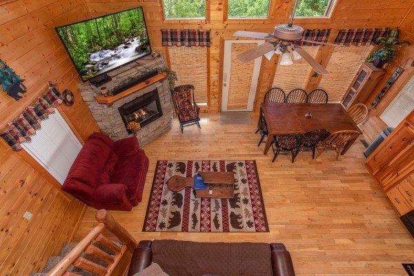 Looking down into the living room from the loft level at Into the Mist, a 3 bedroom cabin rental located in Pigeon Forge
