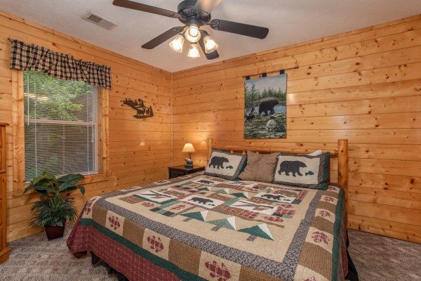 Bedroom with a king-sized log bed at Into the Mist, a 3 bedroom cabin rental located in Pigeon Forge