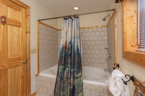 Bathroom with a jacuzzi and shower at Into the Mist, a 3 bedroom cabin rental located in Pigeon Forge