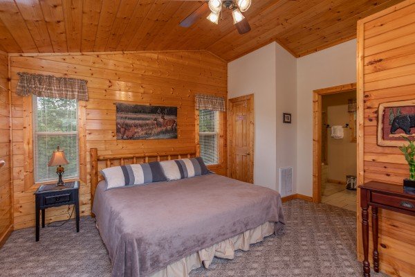 Bedroom with a king sized log bed at Into the Mist, a 3 bedroom cabin rental located in Pigeon Forge