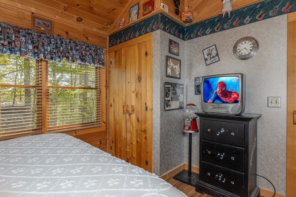 Dresser and TV in a bedroom at Rock Around the Clock, a 1 bedroom cabin rental located in Pigeon Forge