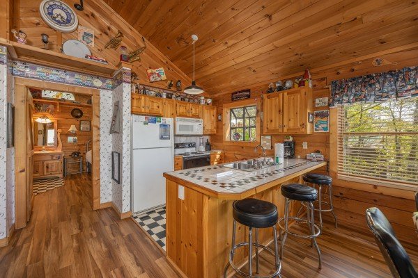 Breakfast bar with three stools at Rock Around the Clock, a 1 bedroom cabin rental located in Pigeon Forge