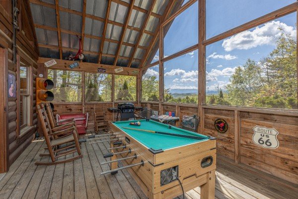 Pool table on the screened in porch at Rock Around the Clock, a 1 bedroom cabin rental located in Pigeon Forge