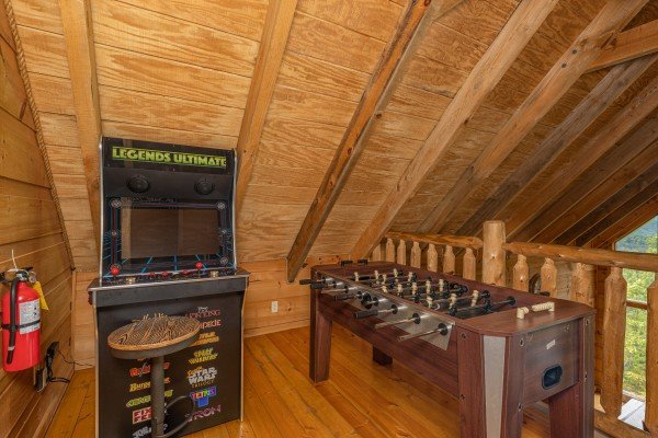 Arcade game and foosball table at Auburn Sky, a 4 bedroom cabin rental located in Pigeon Forge