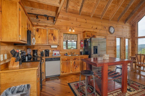 Kitchen with stainless appliances and an island at Auburn Sky, a 4 bedroom cabin rental located in Pigeon Forge