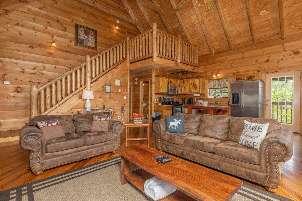 Sofa and loveseat in a living room at Auburn Sky, a 4 bedroom cabin rental located in Pigeon Forge