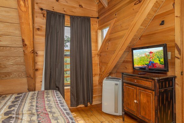 Dresser and TV in a bedroom at Auburn Sky, a 4 bedroom cabin rental located in Pigeon Forge