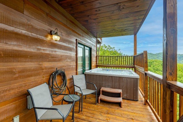 Hot tub on a covered porch at Auburn Sky, a 4 bedroom cabin rental located in Pigeon Forge