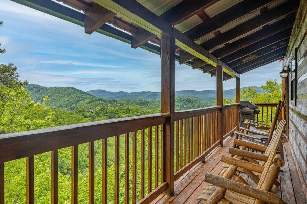 Rocking chairs on a covered deck with a mountain view at Auburn Sky, a 4 bedroom cabin rental located in Pigeon Forge