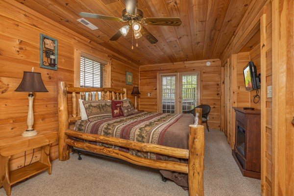 Bedroom with a king bed, dresser, and TV at Auburn Sky, a 4 bedroom cabin rental located in Pigeon Forge
