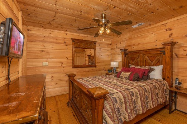 King bed, dresser, and TV in a bedroom at Auburn Sky, a 4 bedroom cabin rental located in Pigeon Forge