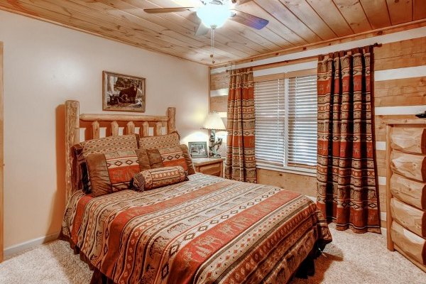 Bedroom with a queen-sized bed, dresser, and television at Creekside Comfort, a 3-bedroom cabin rental located in Pigeon Forge