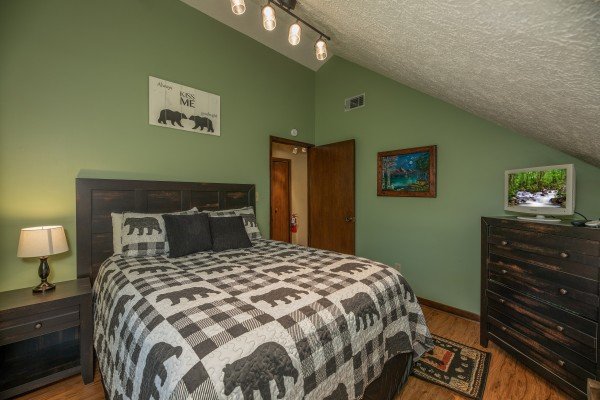 Loft bedroom with nightstand, lamp, dresser, and TV at Misty Mountain Sunrise, a 3 bedroom cabin rental located in Pigeon Forge