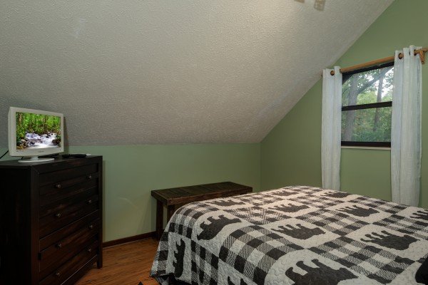 Dresser, TV, and bench in a loft bedroom at Misty Mountain Sunrise, a 3 bedroom cabin rental located in Pigeon Forge