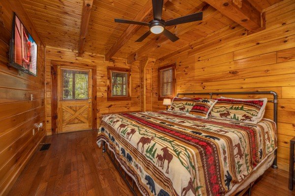 Bedroom with a king bed, TV, and deck access at Silver Creek Cabin, a 1 bedroom cabin rental located in Pigeon Forge